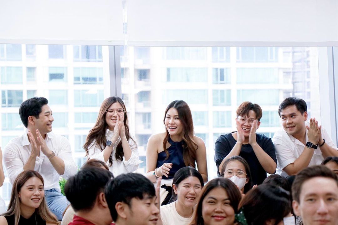 Primal staff seated, applauding and smiling at a company meeting