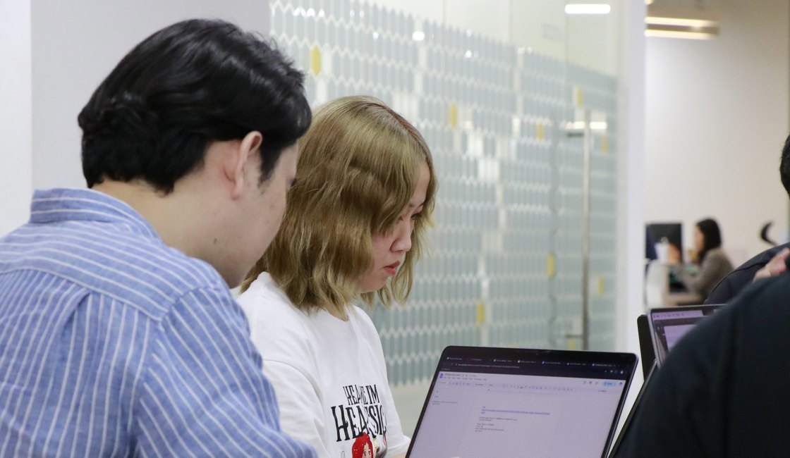 The Primal team collaborating on laptops in the office